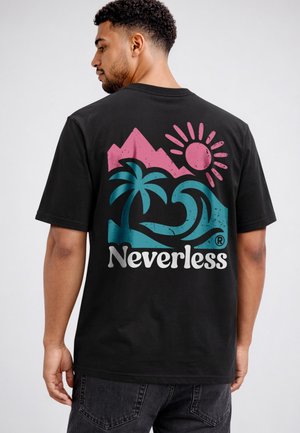 Man wearing black t-shirt with colorful graphic of pink mountains, pink sun, blue palm trees, and waves with "Neverless" text on back.