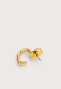 Gold-tone metal earring with a curved shape, featuring a secure post back and a floral accent detail near the fastening.