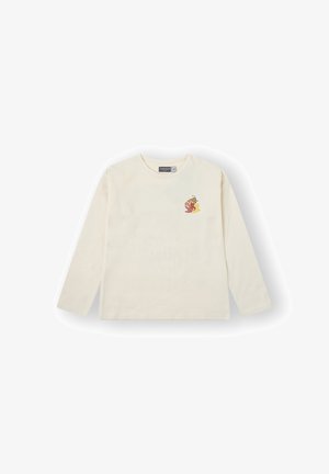 Camiseta de manga larga de color crema hecha de algodón, con un pequeño diseño floral colorido en el lado izquierdo del pecho.