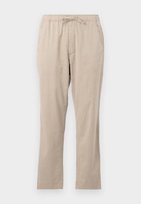 Pantalons beiges légers avec une taille élastiquée, poches avant et cordon de serrage. Texture lisse et design à jambe droite.