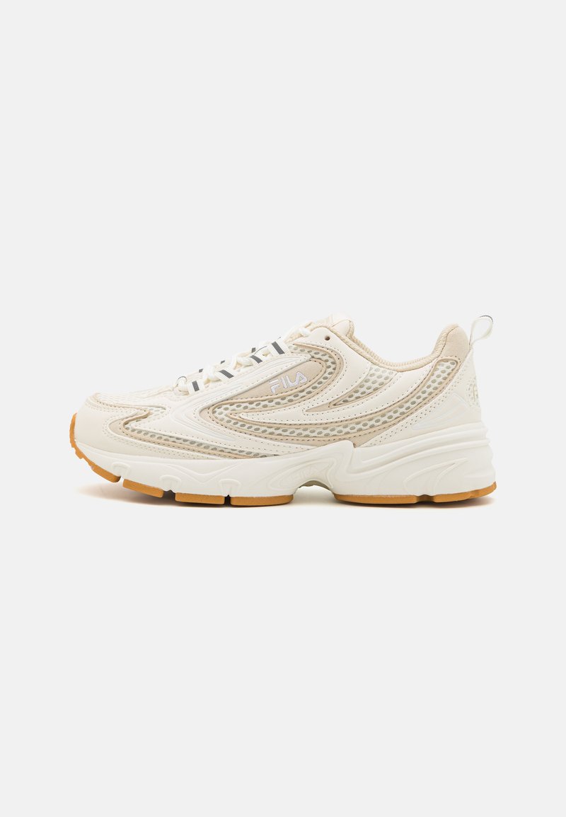 Cream-colored sneaker with mesh and synthetic material, textured accents, and a rubber sole. Features a chunky design and a lace-up front.