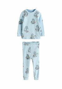 Ljusblå pyjamas med långa ärmar och byxor, med ett upprepat mönster av flickor med blommiga detaljer i svart kontur. Mjuk tygstruktur.