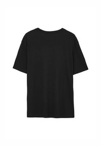 T-shirt in cotone nero con vestibilità rilassata, maniche corte e scollatura arrotondata. Il retro è semplice, senza etichette visibili o decorazioni.