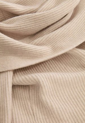 Beige ribbelstof met een zachte textuur, voorzien van smalle verticale strepen. Het materiaal lijkt lichtgewicht en valt soepel.
