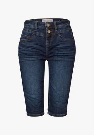 Tmavě modré denimové capri džíny s páskem střední výšky, dvěma předními kapsami a dva knoflíkovými zapínáními. Obsahují kontrastní prošívání a hladkou texturu.