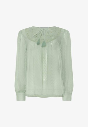 Vaaleanvihreä pusero, joka on valmistettu läpinäkyvästä kankaasta. Ominaisuuksiin kuuluu kuvioitu täplämalli, brodeerattu kaula-aukko ja kaksi tupsua takana kaulassa.