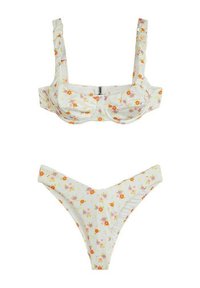 Set bikini floreale con base bianca e fiori arancioni, rosa e gialli. Il top ha spalline arricciate e il fondo ha una forma a V.