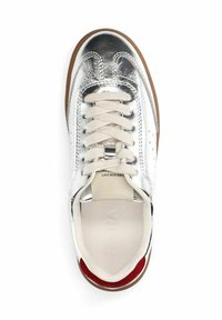 White sneaker with silver metallic accents, rounded toe, and beige laces. Features a cushioned insole and rubber sole with red detailing.