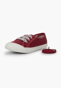 Sneaker in tela rossa con suola in gomma bianca, lacci a motivo floreale e profilo basso. Include un ulteriore laccio rosso.