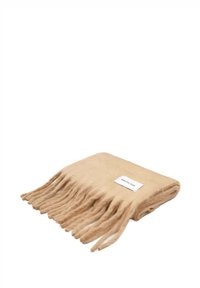 Écharpe beige à franges en laine douce. Présente une étiquette avec "Arctic Fox". Texture lisse, avec de longues franges le long d'un bord.