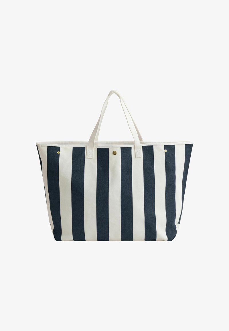 Grand sac fourre-tout avec des rayures verticales bleu marine et blanches, deux poignées blanches, et une petite fermeture éclair centrale par bouton-pression.
