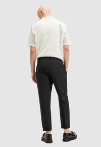 AllSaints - Chinosy