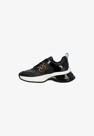 Black patent leather sneaker with textured panels, white sole, and a gold metal logo accent on the side. Features padded collar and laces.