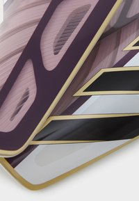 Graphic design featuring a layered composition of pink, white, and black materials with curved shapes and gold accents.