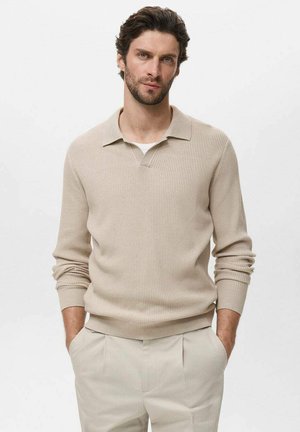 Beige ribbed knit pullover with a collar and long sleeves, paired with light-colored trousers. Smooth texture with a casual fit.