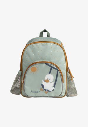Backpack in light green fabric with polka dots, featuring a duck graphic, orange sun, and mesh side pockets. Accented with a brown zipper.
