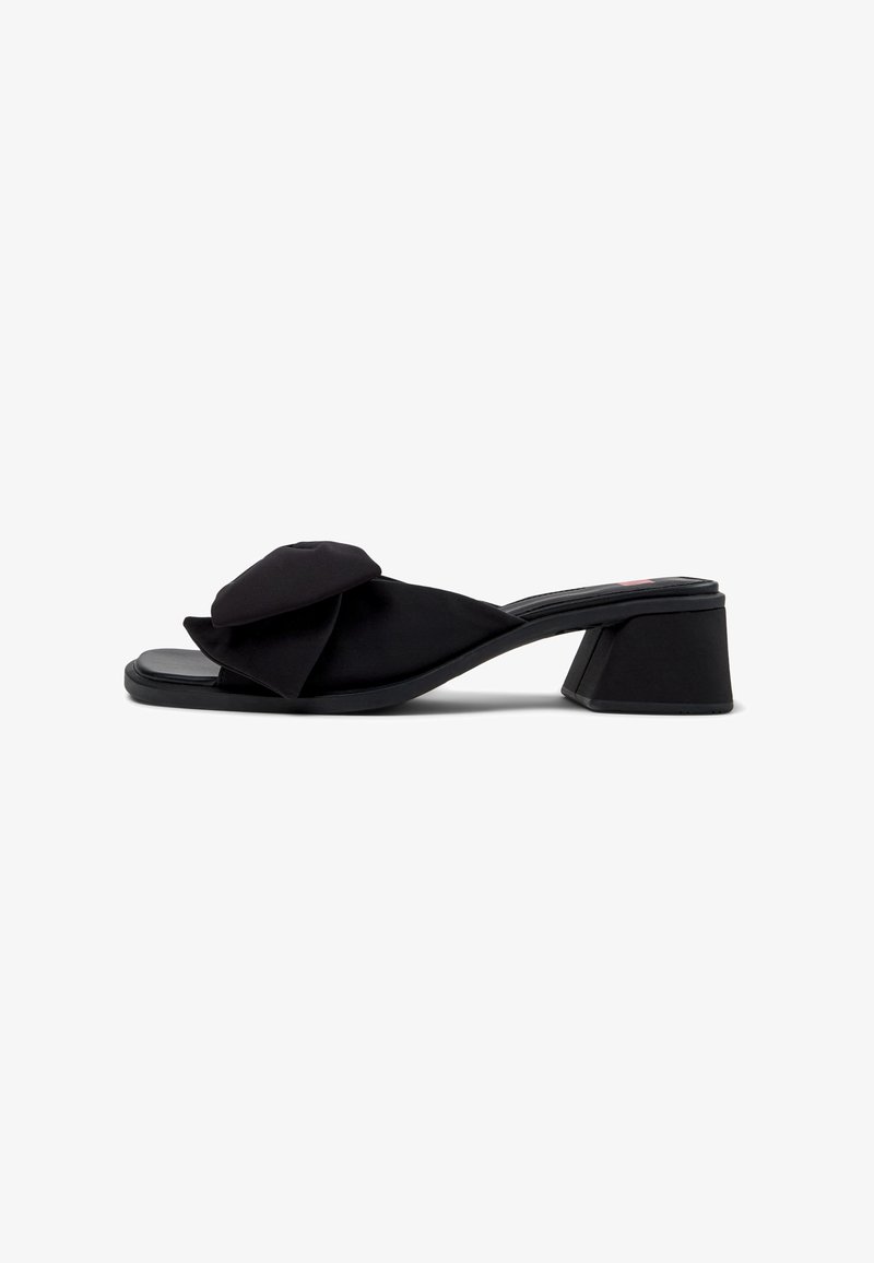 Black satin slide sandal with a large ruffled bow detail on the upper, open toe, and a sturdy, geometric block heel.