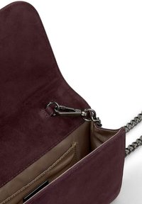 Burgundowa zamszowa torebka na ramię z łańcuszkiem, z zamykaną kieszenią, bezpiecznym zapięciem oraz wewnętrzną kieszenią na drobiazgi.
