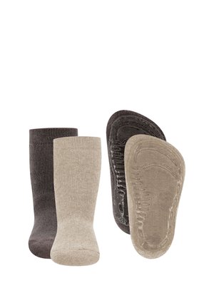Two pairs of no-show socks in dark gray and beige, showing both upright and sole views with textured grips on the soles.