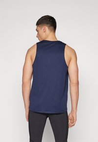 Navy blue athletic tank top with a simple design, sleeveless cut, and a round neck. Soft texture and regular fit, suitable for active wear.