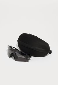 Black sports sunglasses with a curved shape and dark lenses beside a rounded, hard black case with a zipper.