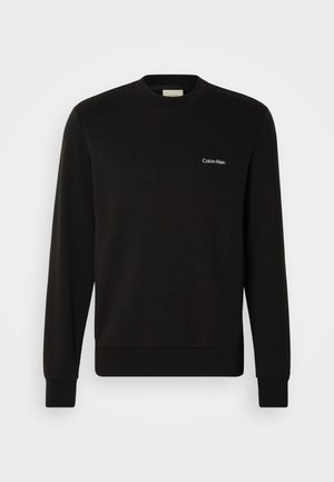 Black sweatshirt made of soft cotton blend, features a crew neck, long sleeves, ribbed cuffs, and a small white logo on the chest.
