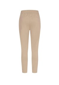 Beige leggings med en tettsittende design, elastisk midje og et par baklommer. Laget av mykt stoff, egnet for hverdagsbruk.
