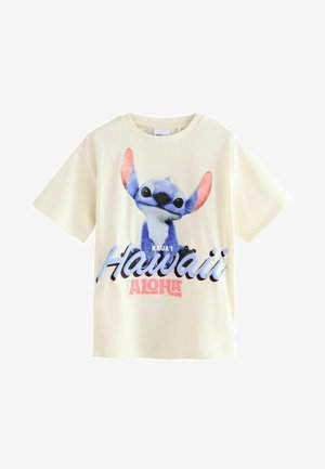Kremna bombažna majica s kratkimi rokavi, ki prikazuje modrega risanega junaka s pink ušesi in napisom "Kaua'i Hawaii Aloha" v barvnem tisku.