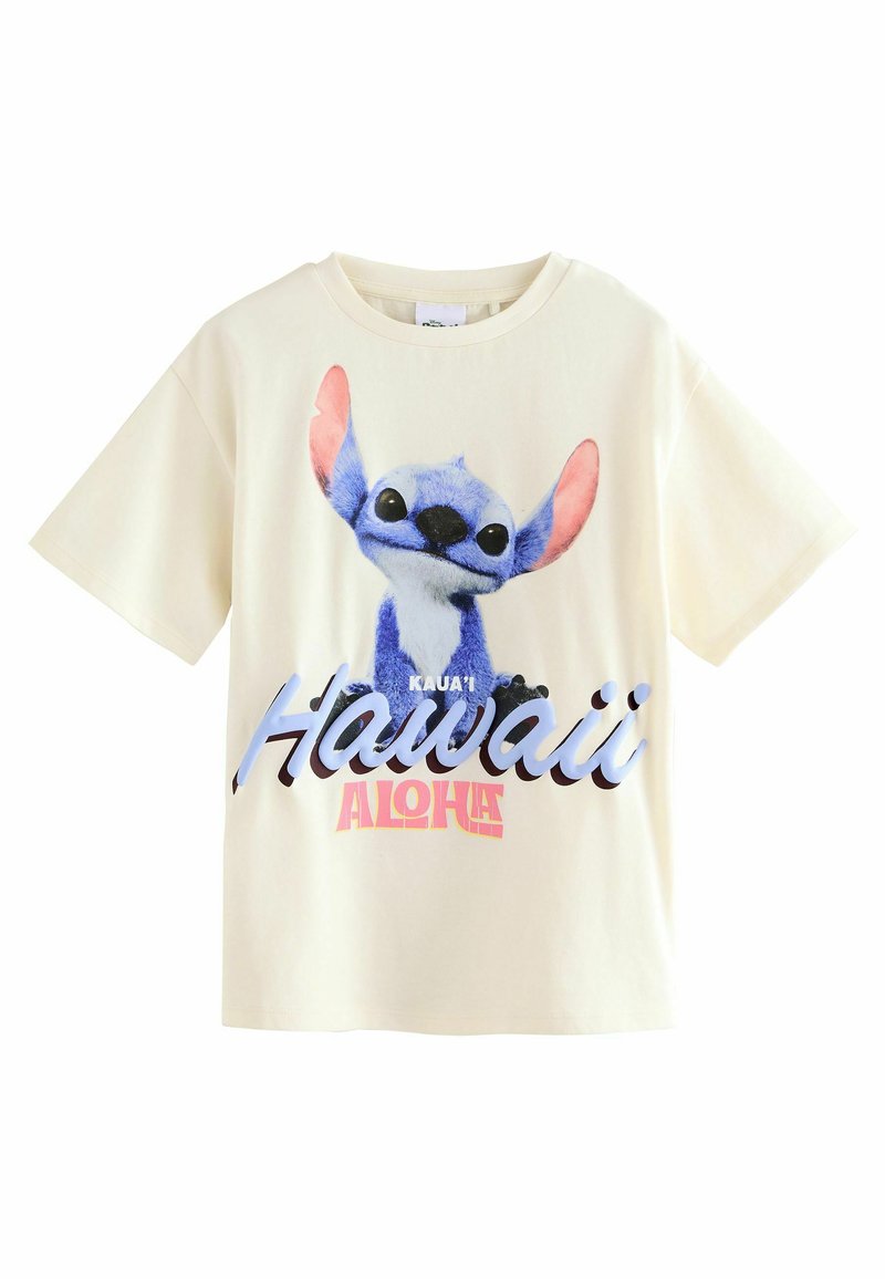 Camiseta de algodón color crema que presenta un personaje de dibujos animados azul con orejas rosas y el texto "Kaua'i Hawaii Aloha" en una impresión colorida. Mangas cortas.