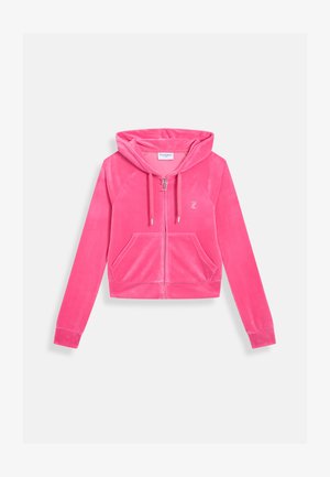 Roze ritsjack in zachte fluweel. Beschikt over een capuchon, twee vo zakken en een klein geborduurd logo. Kort model met lange mouwen.