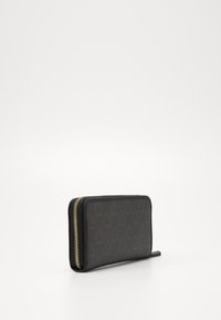 Black zip-around wallet with a smooth finish, featuring a subtle geometric pattern and gold-tone zipper hardware for added detail.