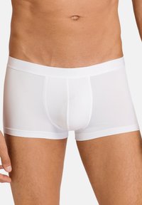 White cotton boxer briefs with a smooth finish, featuring a soft waistband and contoured pouch for comfort. Minimalist design, no patterns.