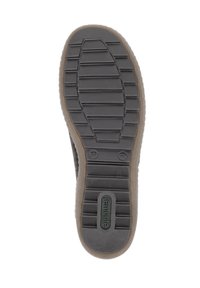 Semelle de chaussure en caoutchouc noir avec des motifs de grip texturés et des rainures ; présente un bord brun clair et un logo de marque en relief en vert.