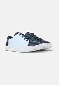 Blue and navy leather sneakers with a green accent, textured surface, white speckled sole, and blue laces. Rounded design, low profile.