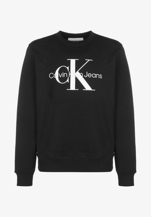 Juodas džemperis, pagamintas iš medvilnės mišinio, su apvalia apykakle, raukšlėtomis rankovėmis ir dideliu baltu Calvin Klein logotipu priekyje.