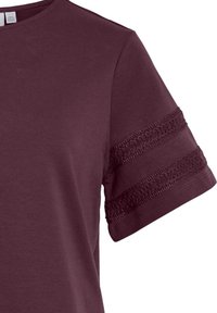 Short-sleeve maroon t-shirt featuring lace detail on the sleeves, made of soft cotton for comfort. Simple crew neck design.