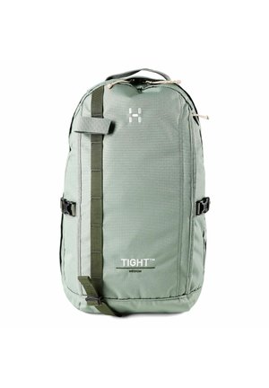 Middelgrote lichtgroene rugzak met verticale riem aan de voorkant, zijgespen, bovenste handvat en "TIGHT" merknaam op het voorvak.