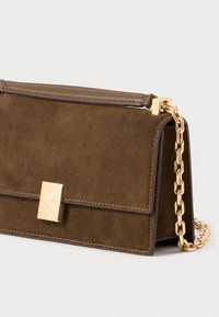 Brown suede handbag with a gold chain strap, featuring a square gold clasp and tonal stitching. Compact design with a structured shape.