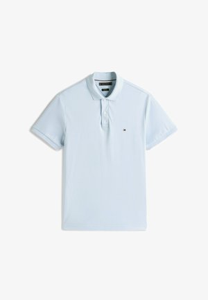Light blue polo shirt made of cotton. Features a classic collar, three-button placket, and a small, embroidered logo on the chest.