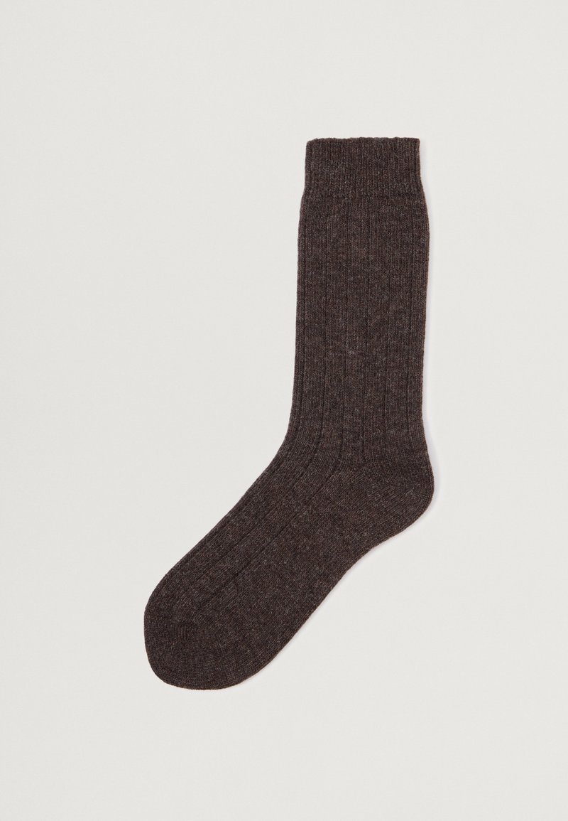 Mörkbrun ribbad strumpa tillverkad av texturerat material; har en förstärkt häl och mudd för ökad hållbarhet och passform.