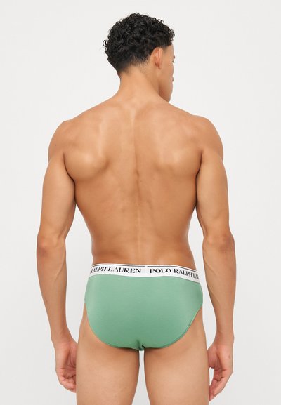 Grüne Baumwollslips mit einem weißen Bündchen, auf dem "POLO RALPH LAUREN" steht. Das Design zeichnet sich durch einen engen Schnitt und keine sichtbaren Muster aus.