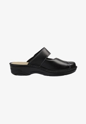 Black leather clog with a wide strap and cushioned insole, featuring a textured surface and a sturdy rubber sole with a slight heel.