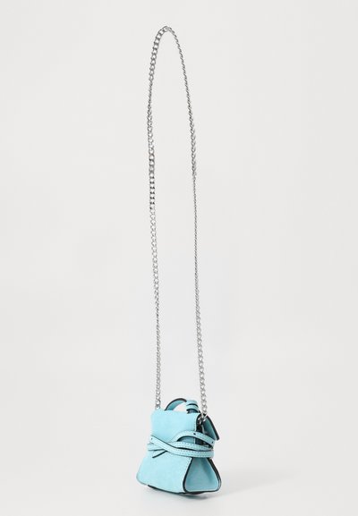 Light blue suede purse with a silver chain strap, gathered design, and contrasting black edges. Features a decorative knotted detail.