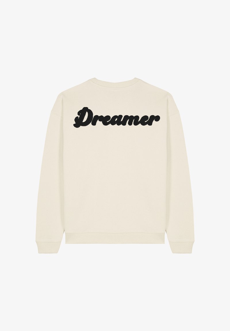 Sweatshirt crème avec le texte noir "Dreamer" au dos, col rond et poignets côtelés ; tissu doux avec une finition lisse.