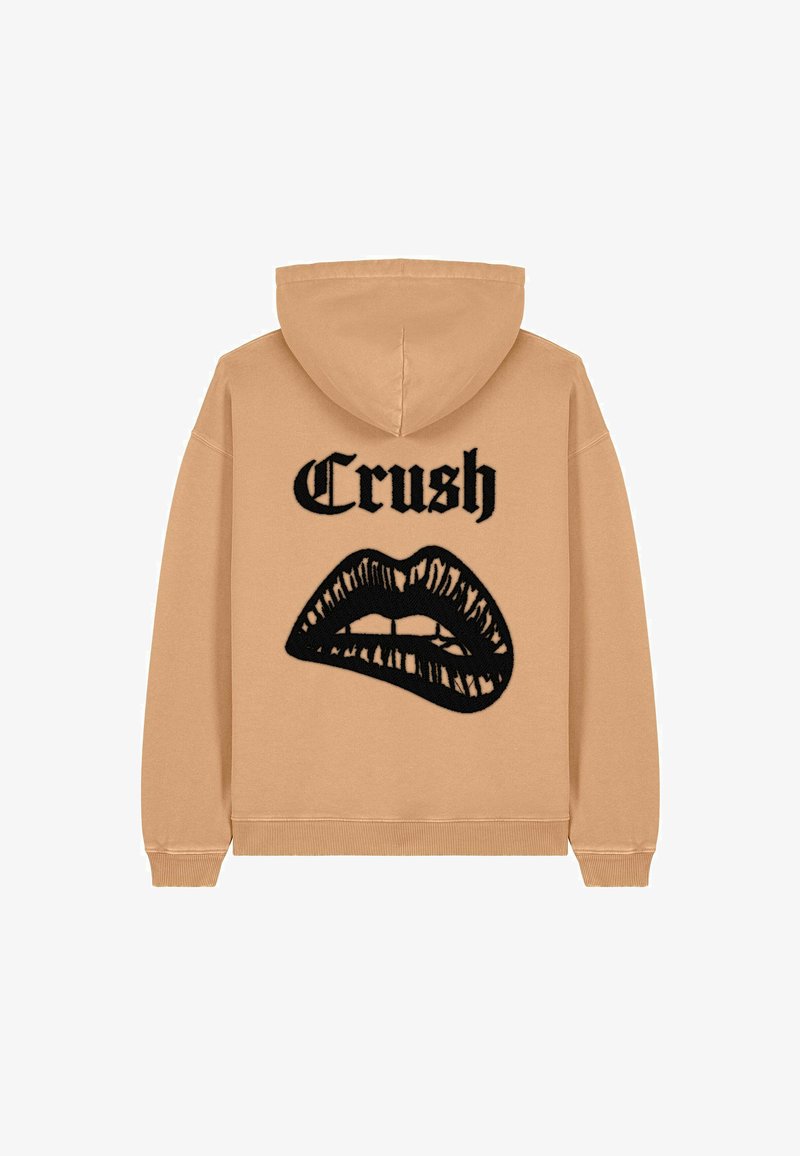 Sweatshirt à capuche en coton beige avec un design graphique noir de lèvres et le mot "Crush" imprimé au-dessus. Poignets et ourlet côtelés.