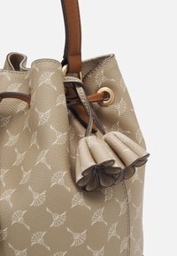 Beiger Bucket Bag aus strukturiertem Leder, mit floralem Muster, zwei gerafften Akzenten und einem braunen Riemen mit goldener Hardware.