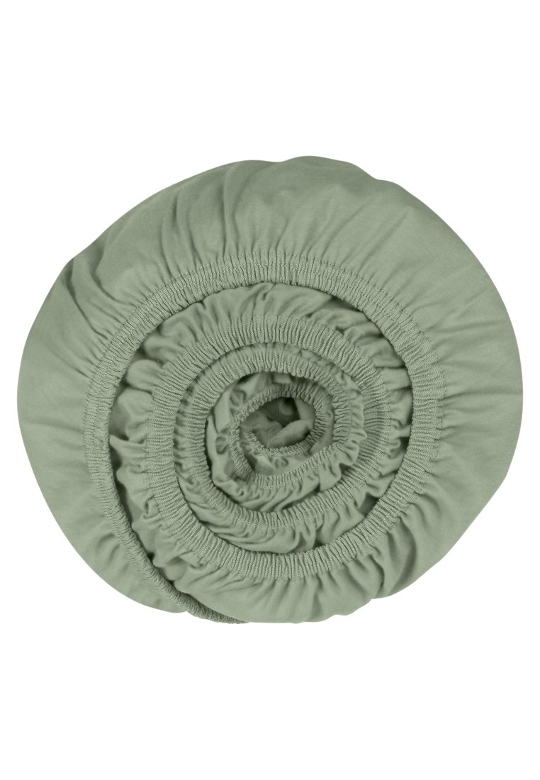Rund, hellgrünes Spannbettlaken, zu einer Spirale gerollt. Hergestellt aus weichem, dehnbarem Stoff mit gerafften Rändern für einen besseren Sitz. Keine Muster oder Akzente.