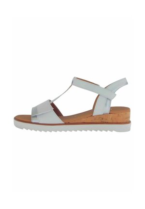 Sandale en cuir blanc avec semelle en liège, semelle en caoutchouc, design en T et bride arrière réglable. Texture lisse et style minimaliste.