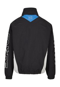 Black lightweight windbreaker jacket with a blue accent on the collar and white side panels. Features logo and text details on sleeves.