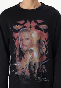 Black long-sleeve shirt featuring a colorful graphic print of characters from "Star Wars: Episode I - The Phantom Menace."